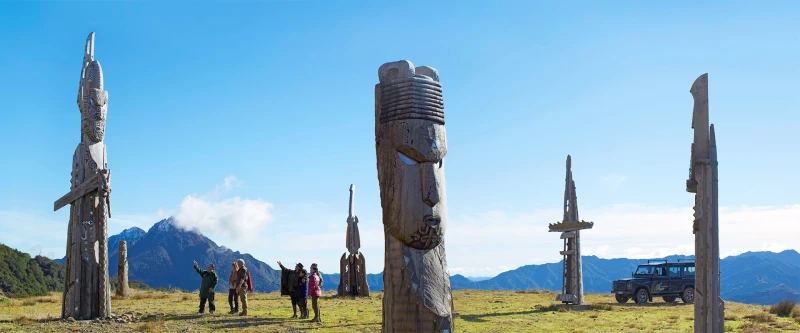 Whakairo carving silhouetted against sunrise at Maunga Hikurangi sacred mountain near Gisborne
