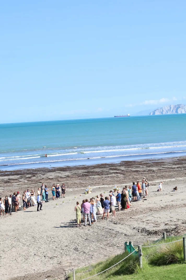 Beach wedding ceremony on Midway Beach with Poverty Bay headland in background Gisborne