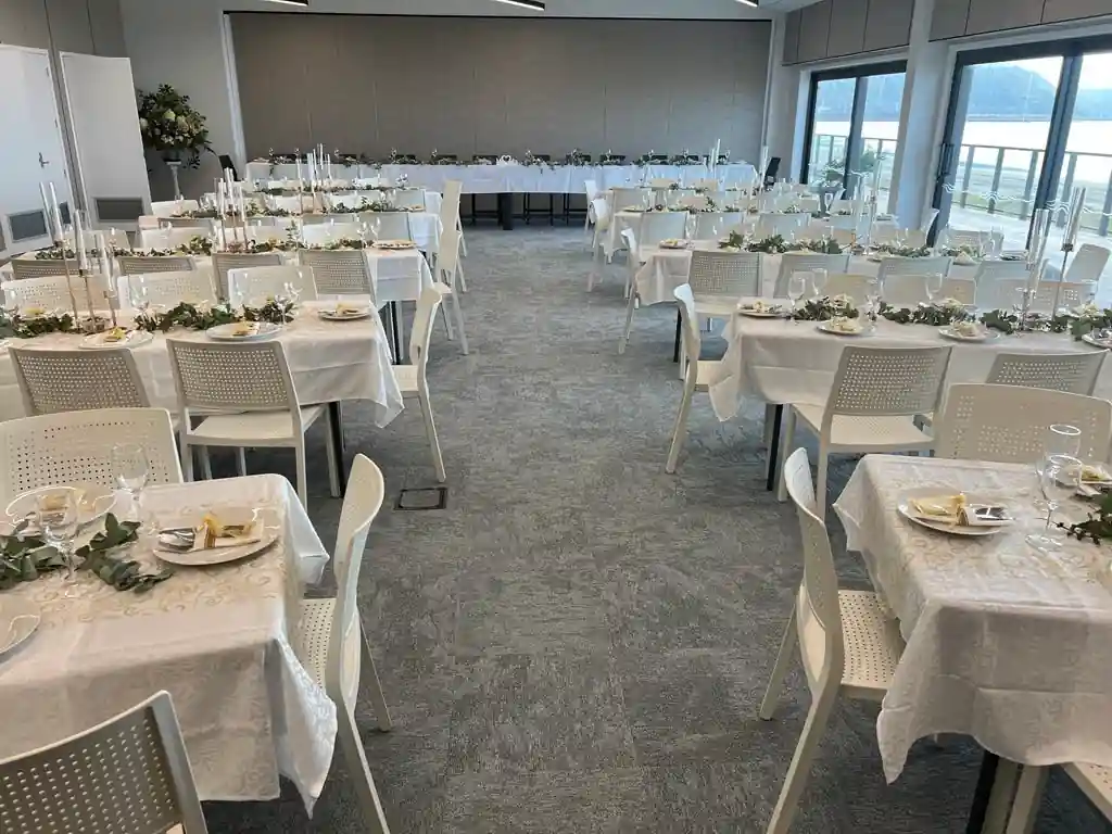 Affordable beachfront wedding reception with all tables facing the ocean Gisborne