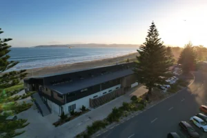 Aerial view of Midway Community Hub beachfront wedding venue at sunset overlooking Poverty Bay, Gisborne