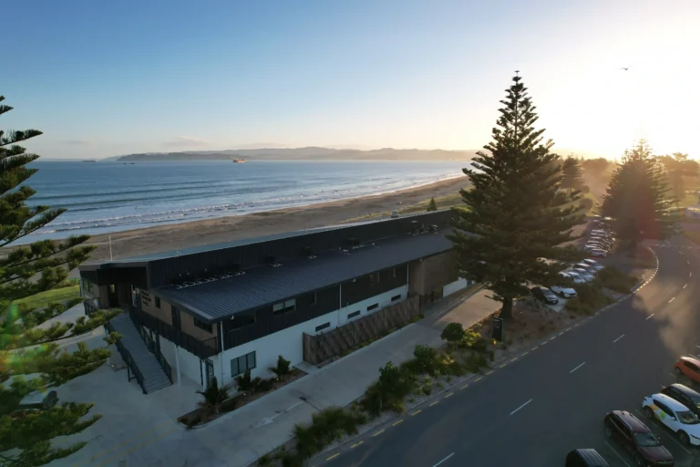 Aerial view of Midway Community Hub beachfront wedding venue at sunset overlooking Poverty Bay, Gisborne