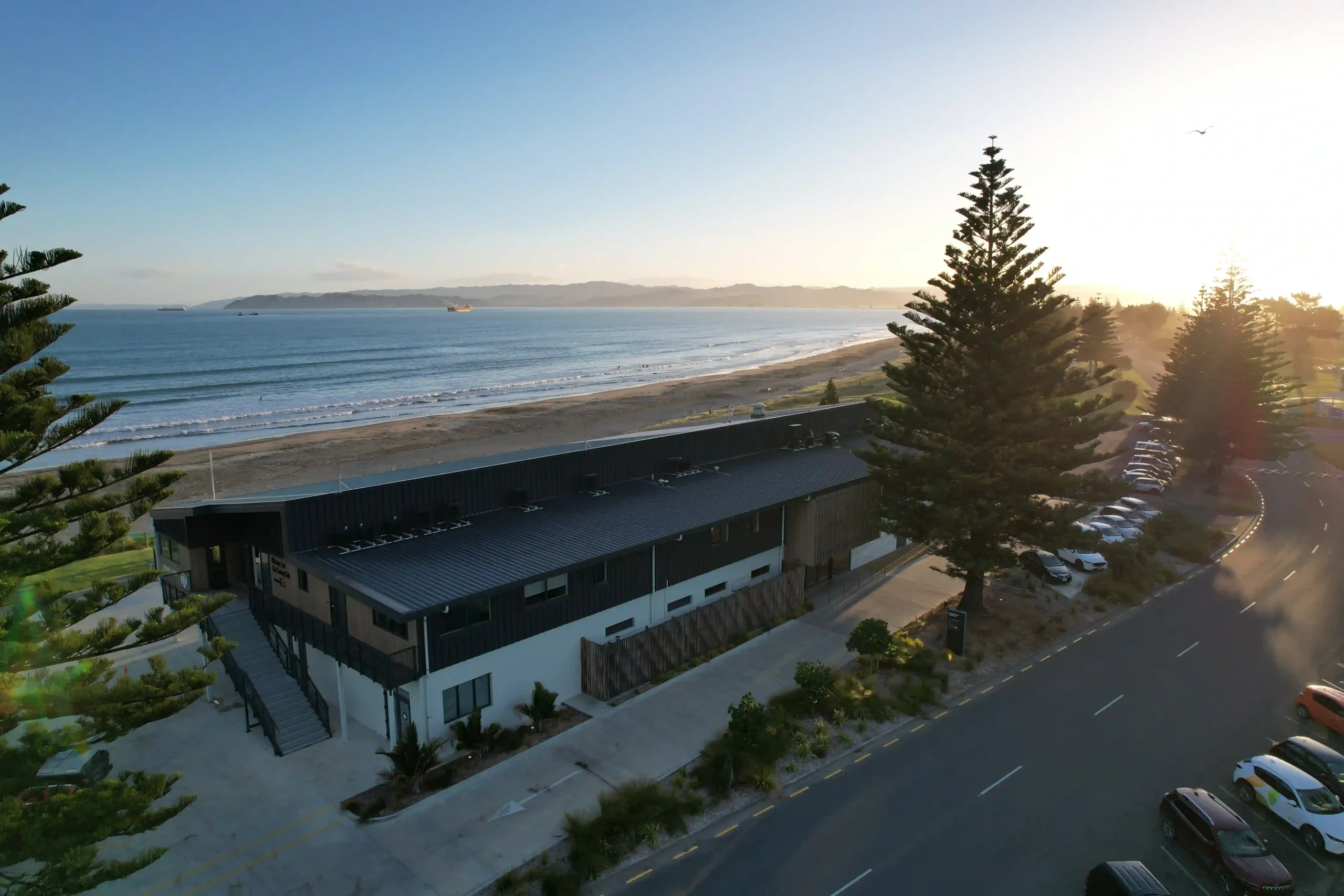 Aerial view of Midway Community Hub beachfront wedding venue at sunset overlooking Poverty Bay, Gisborne