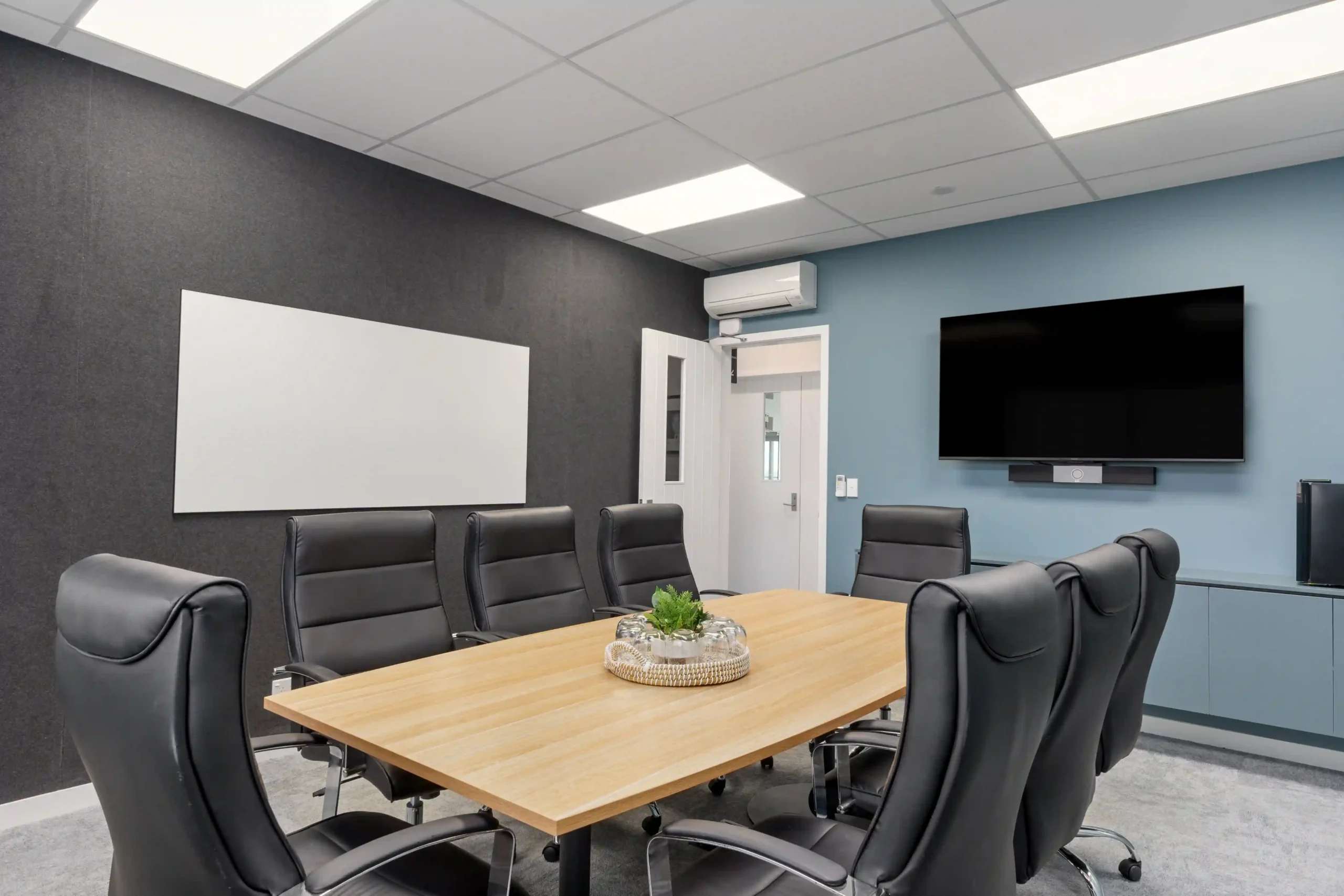 Midway Hub boardroom with whiteboard TV screen and dark feature wall for video conferencing in Gisborne