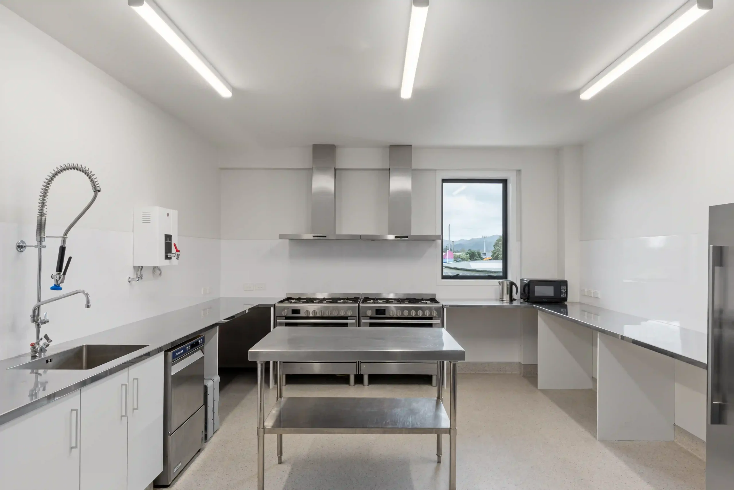 Commercial kitchen with stainless steel prep area at BYO venue Midway Hub Gisborne