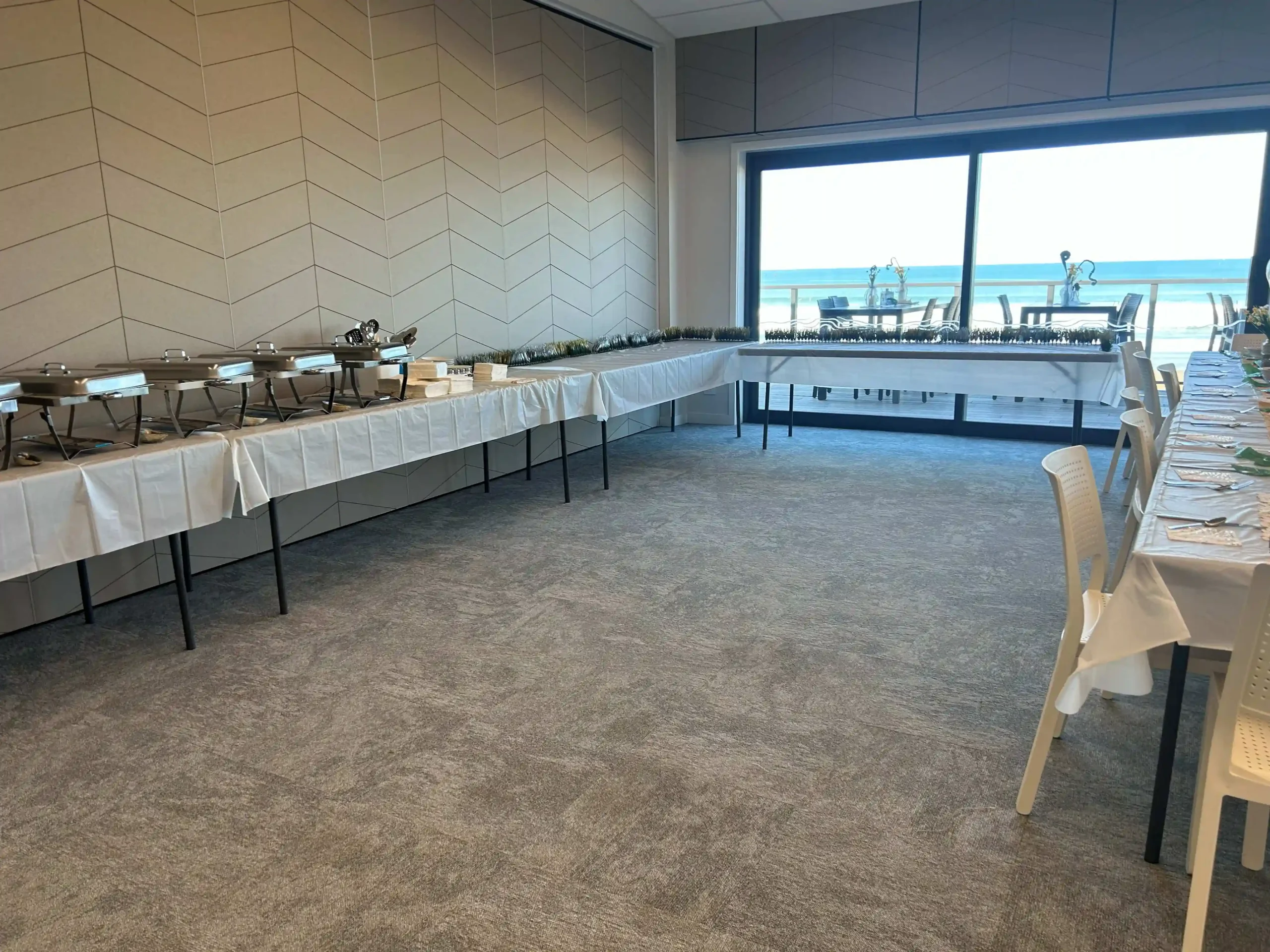 Buffet catering setup with chafing dishes and ocean view at venue hire Gisborne