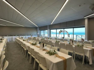 Mana Moana Lounge set up for a beachfront wedding reception with floral arch and ocean views, Gisborne