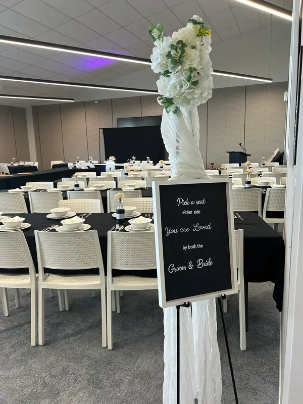 Pick a seat not a side chalk wedding sign with floral easel at Gisborne venue