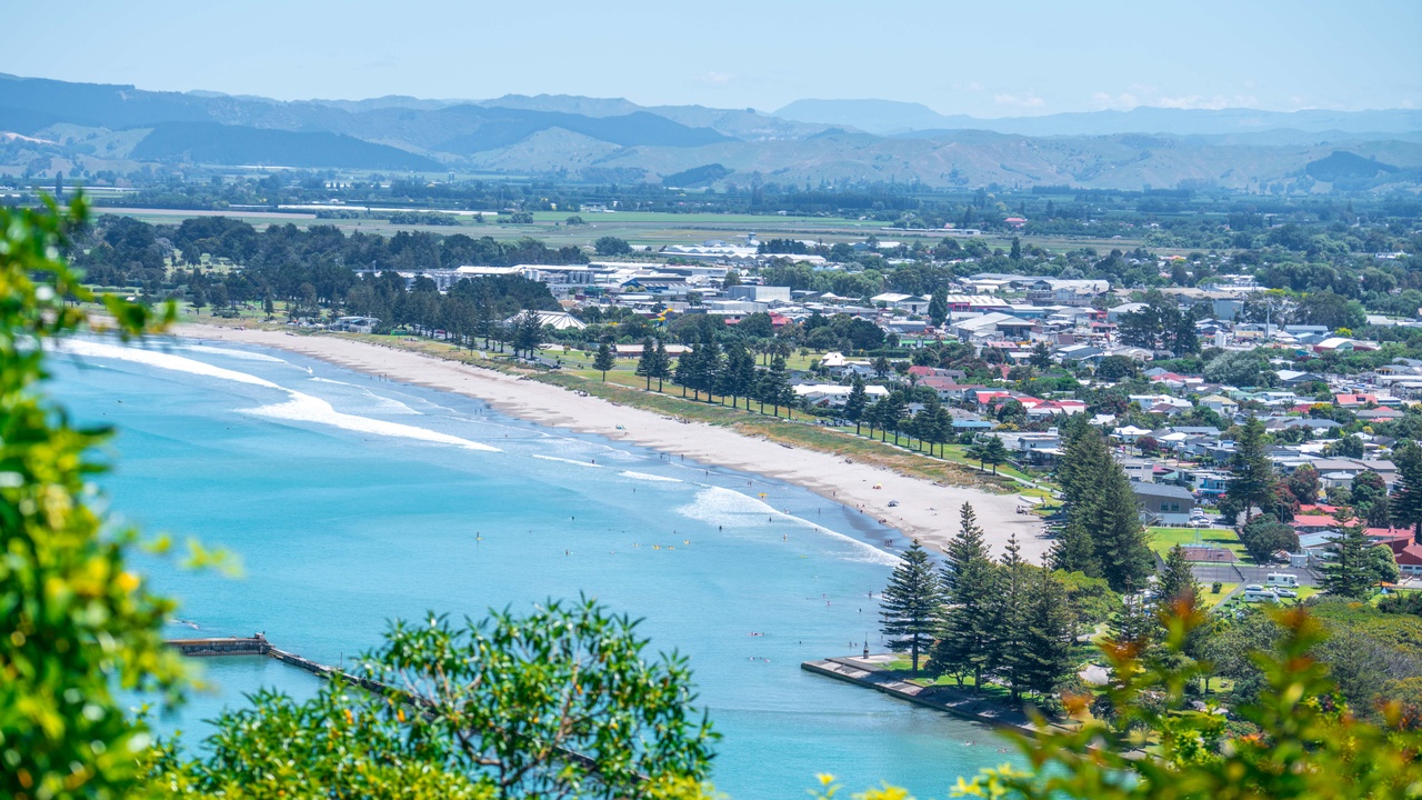 Panoramic view from Kaiti Hill lookout over Waikanae Beach and Gisborne city with mountains
