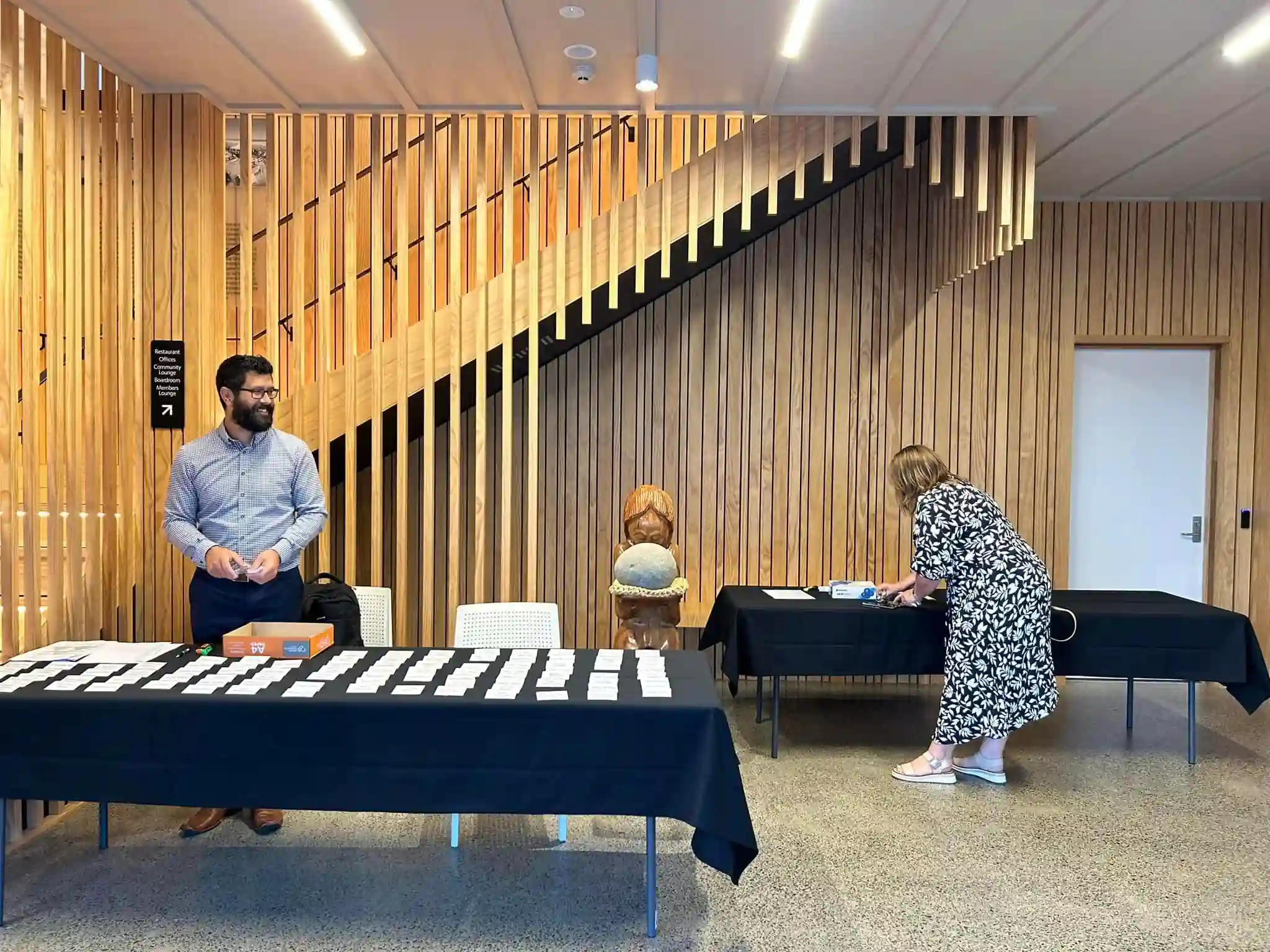 Midway Hub foyer registration desk with timber staircase for event check-in area Gisborne