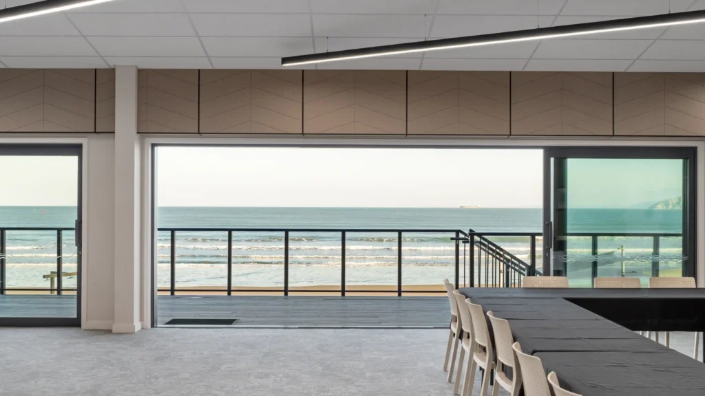 Empty Midway Hub function room with ocean views through open bifold doors ready for event setup Gisborne