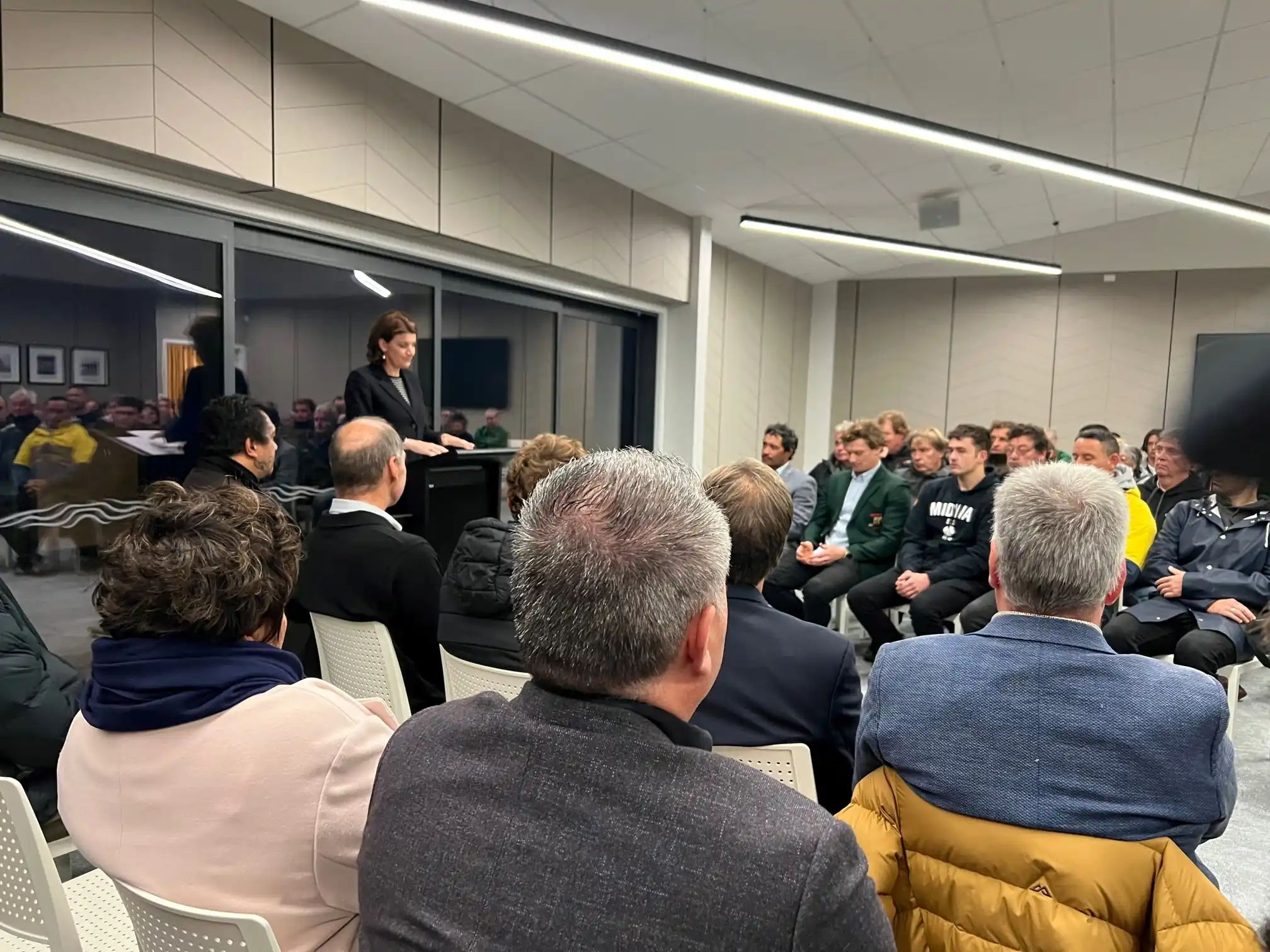 Community event with speaker at podium and seated audience at Midway Community Hub Gisborne