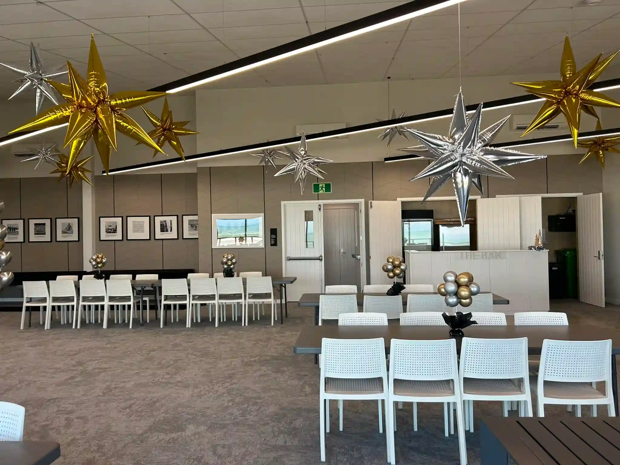 Work Christmas party set up with star balloons and dining tables at a New Zealand venue