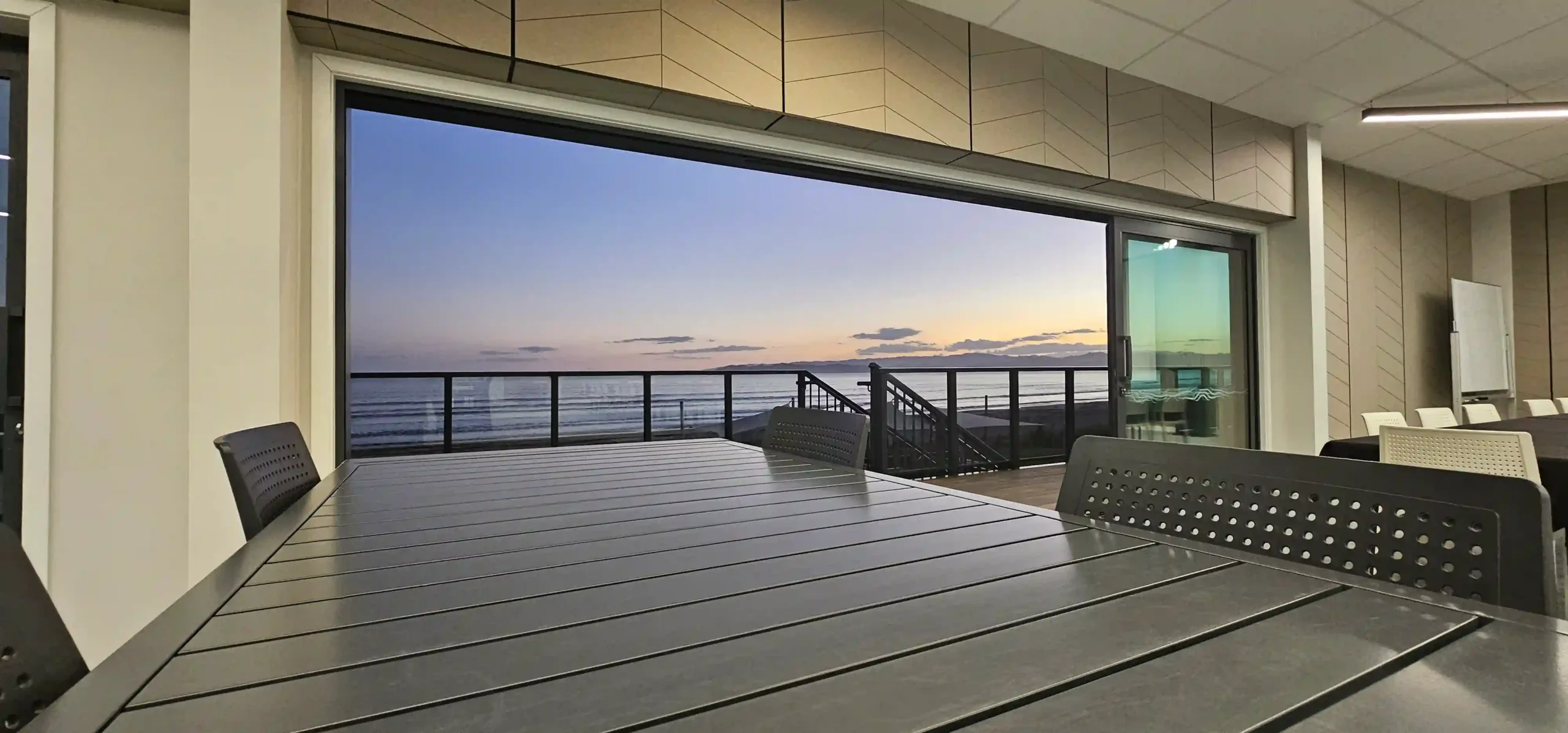 Function room with bifold doors open to the deck for an indoor-outdoor Gisborne Christmas party