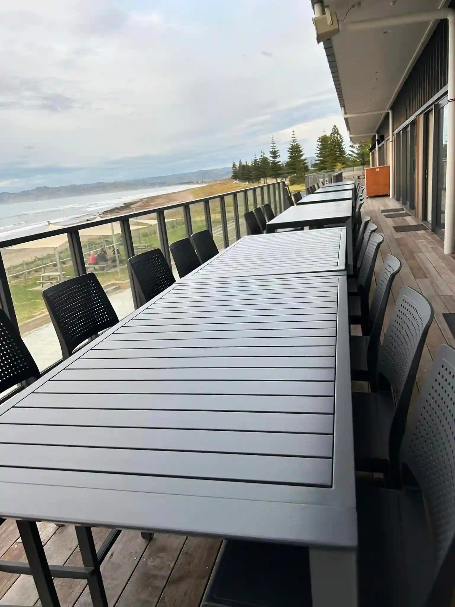 Outdoor deck dining table with beach and ocean views for an outdoor staff Christmas party